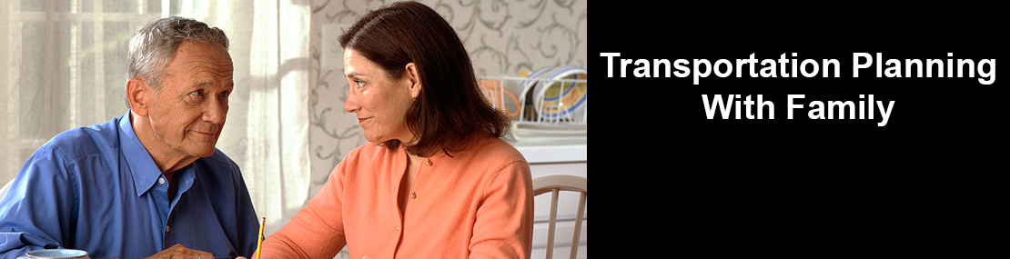 Older man and young woman speaking to each other seated at a table. 