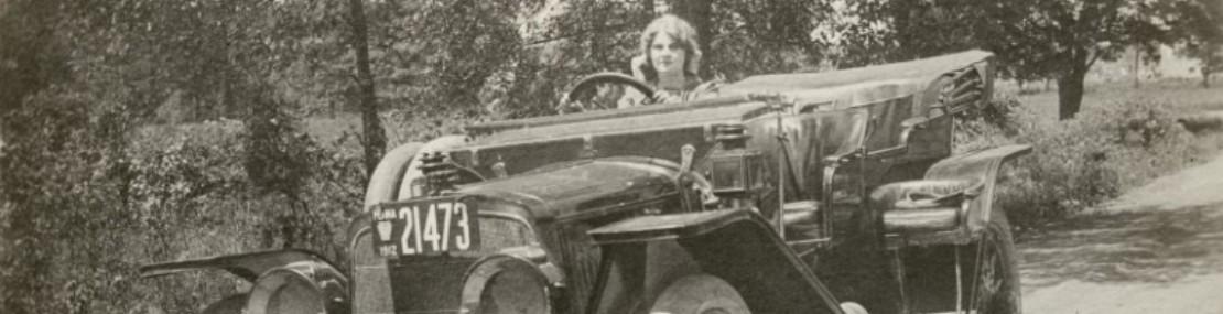 Florence Lawrence in the driver's seat of a car. 