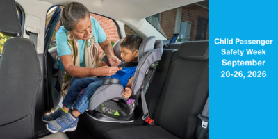 An older adult properly fastens a child into a child safety seat, Child Passenger Safety Week September 20-26, 2026.