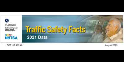 older man driving a car.